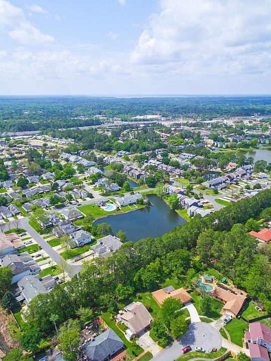 an aerial view of a neighborhood with lots of trees and water at The Vista Bay