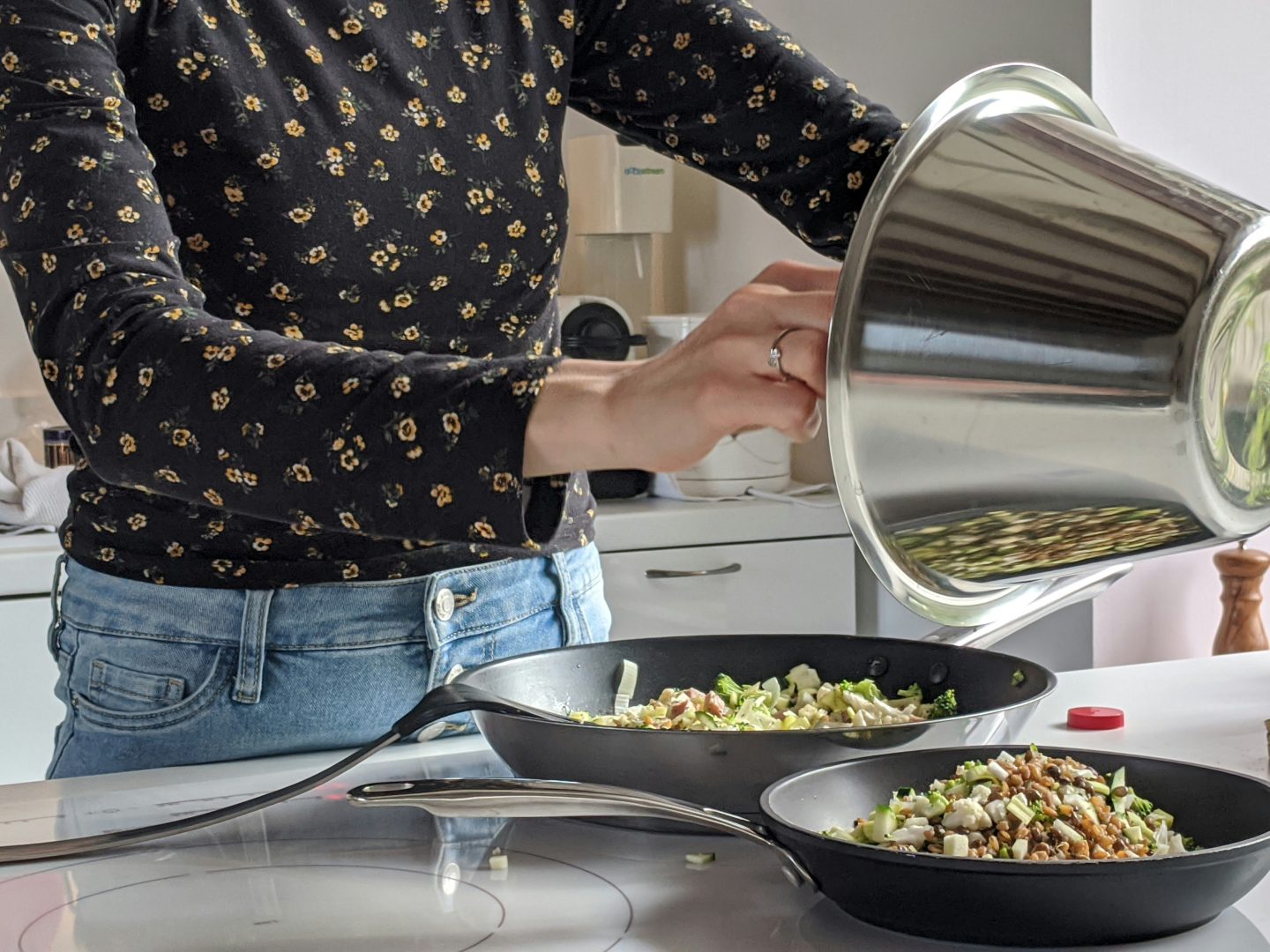 a woman is cooking in a pan with a lid at The Vista Bay