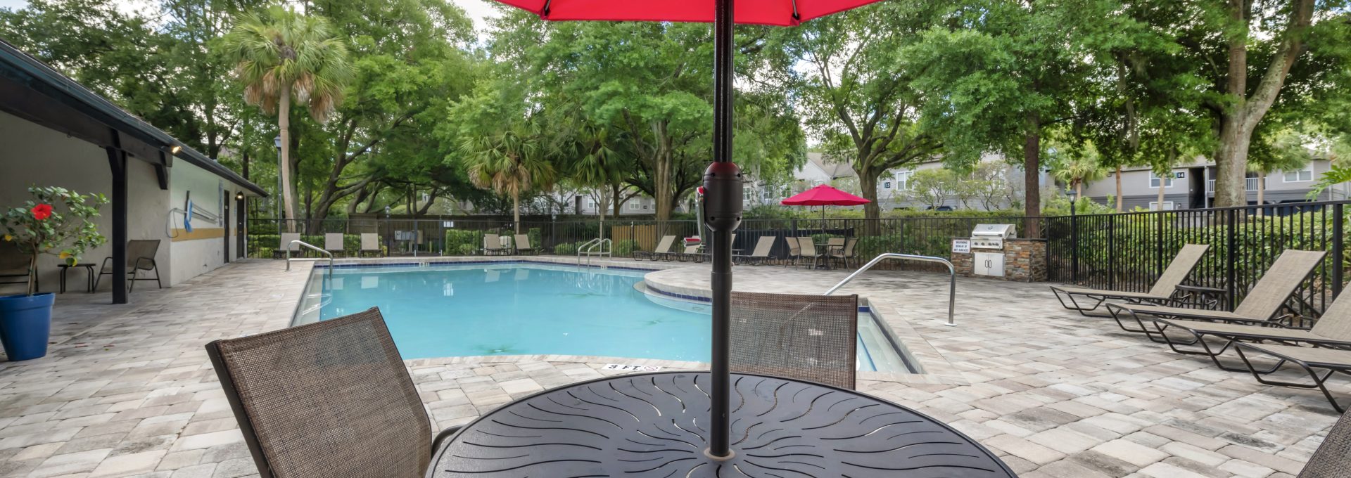 a patio table and chairs with an umbrella over it at The Vista Bay