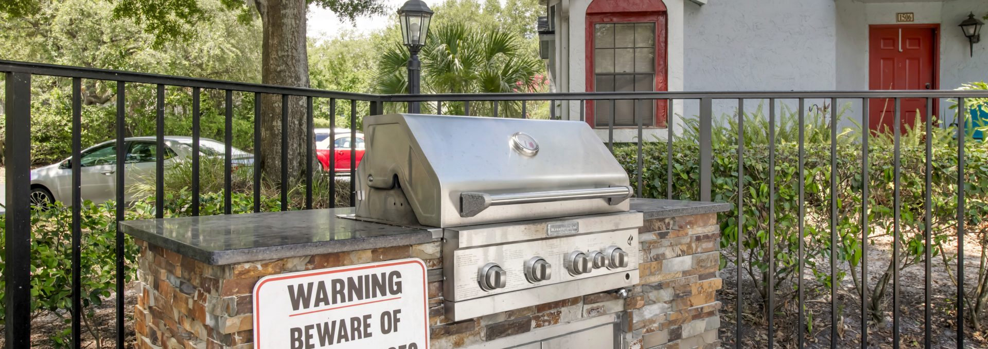 a grill is outside of a home with a sign that says warning at The Vista Bay