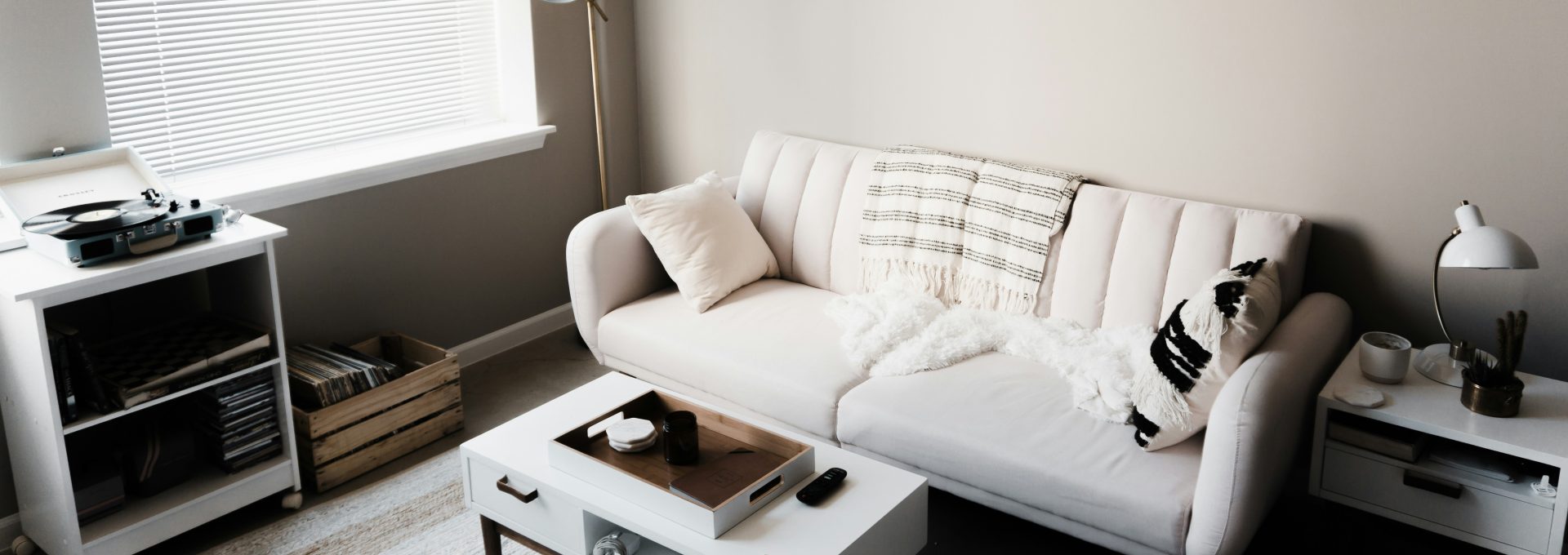 white couch in front of white wooden table