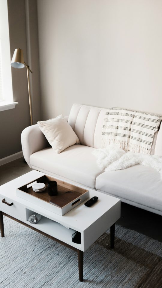 white couch in front of white wooden table