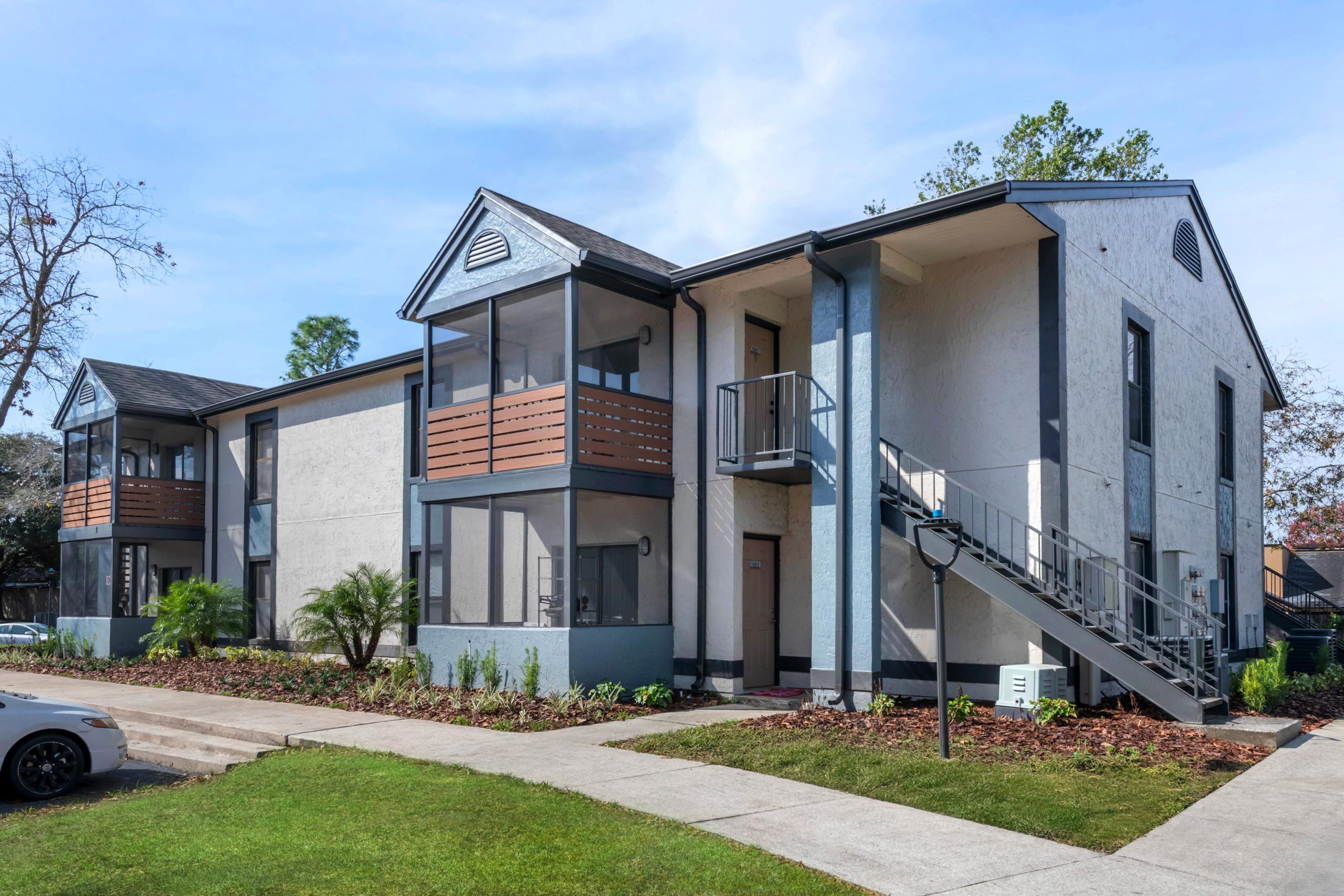 the exterior of an apartment building with stairs and a parking lot at The Vista Bay