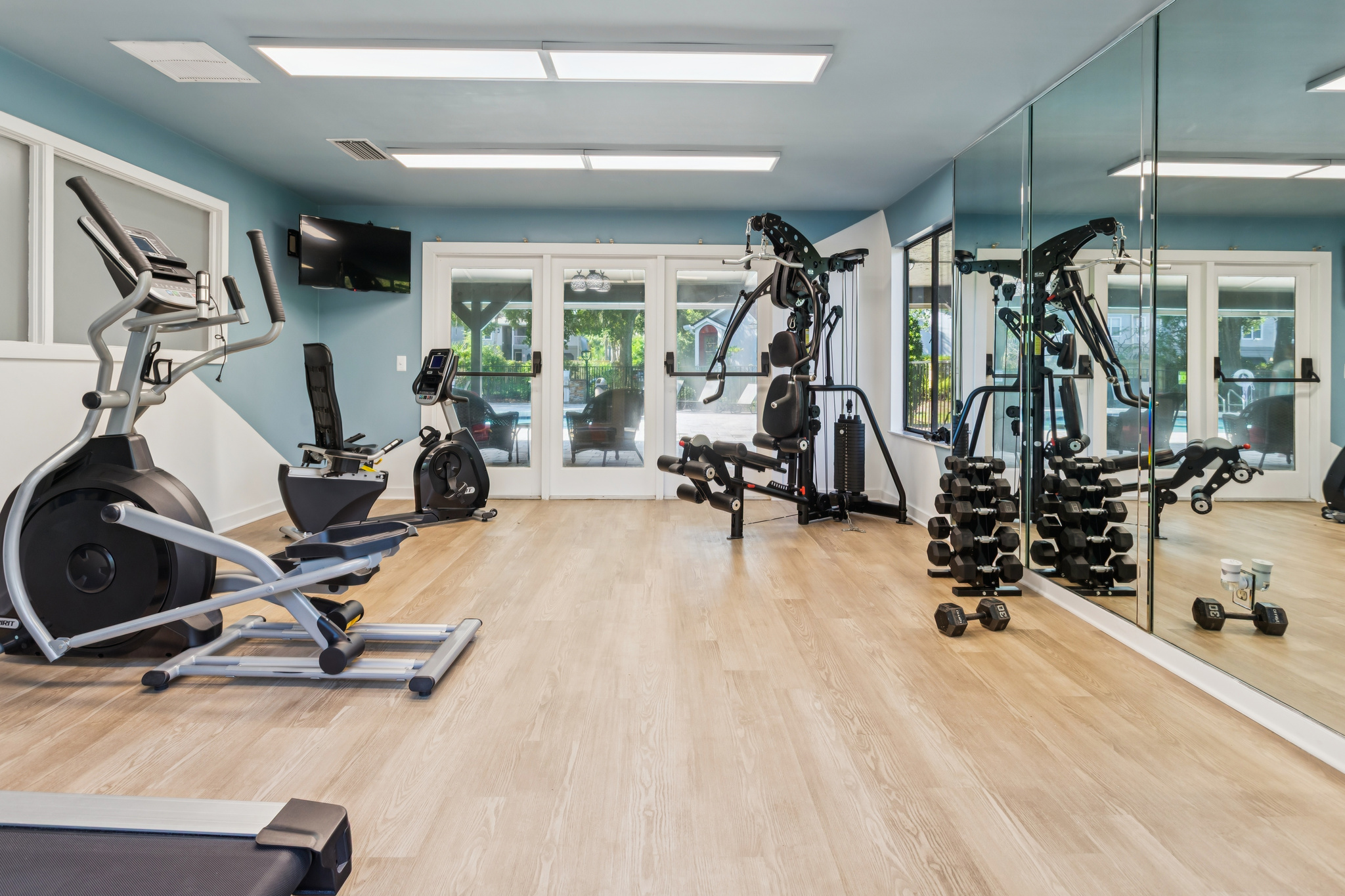 a gym room with exercise equipment and mirrors at The Vista Bay