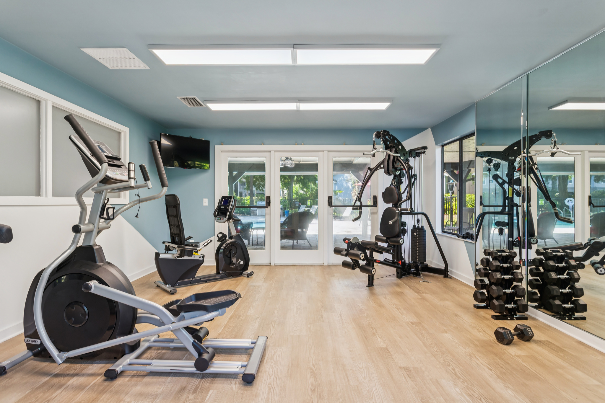 a gym room with exercise equipment and mirrors at The Vista Bay