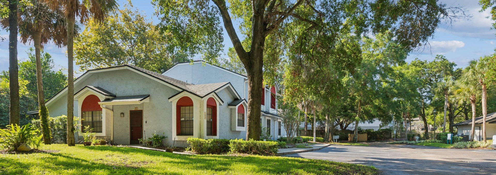 a home in the middle of a neighborhood with trees and grass at The Vista Bay