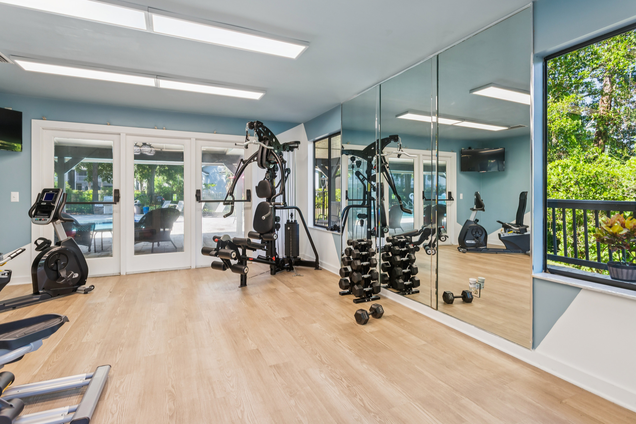 a gym room with mirrors and exercise equipment at The Vista Bay