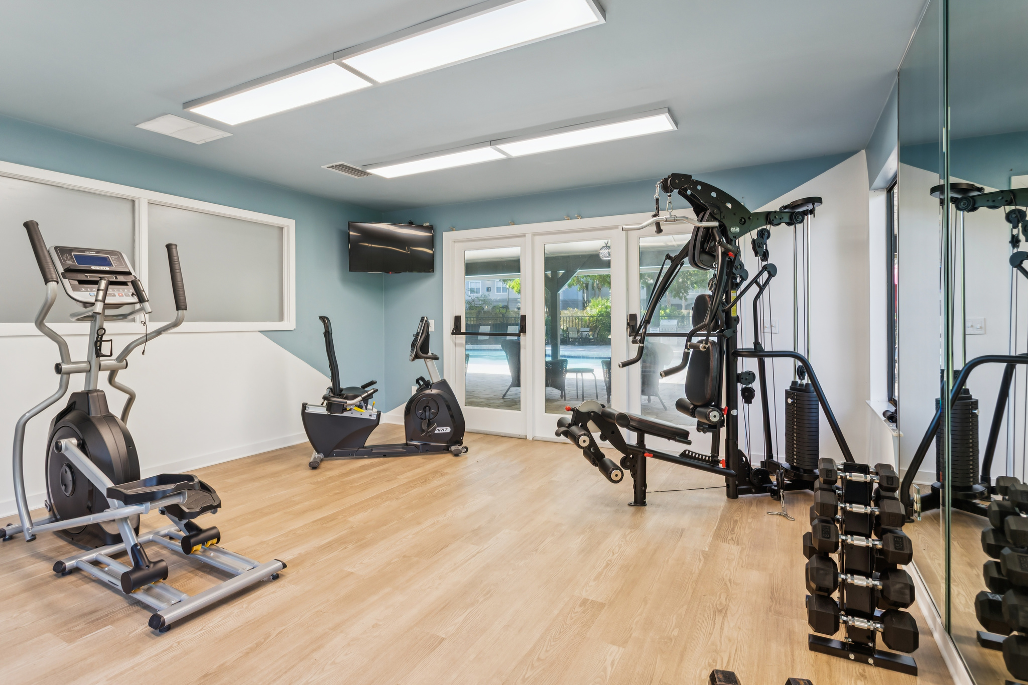 a gym room with exercise equipment and mirrors at The Vista Bay