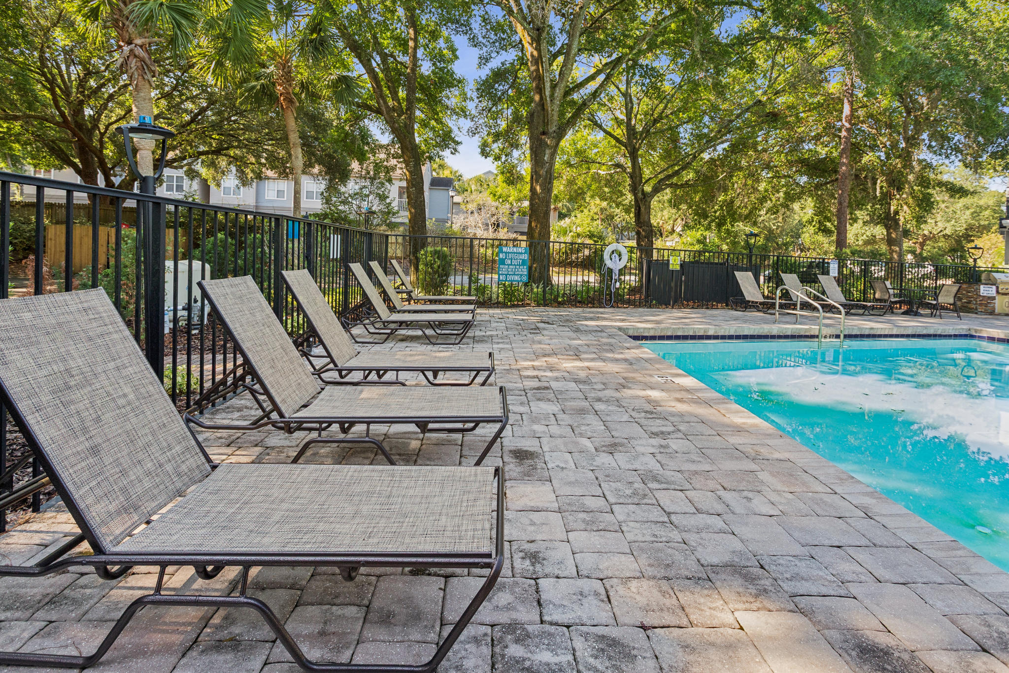 pool chairs and a pool at a resort at The Vista Bay