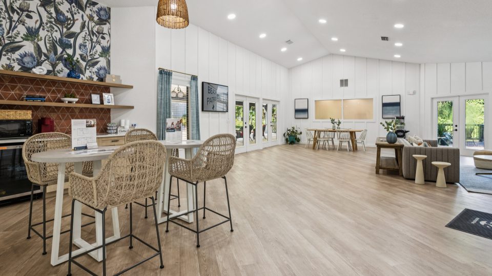 the living room has a wood floor and a large table at The Vista Bay
